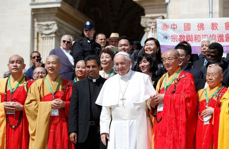 Pope Francis poses with monks from Taiwan, at the end of the weekly general audience in the Vatican, May 22, 2019. REUTERS/Remo Casilli