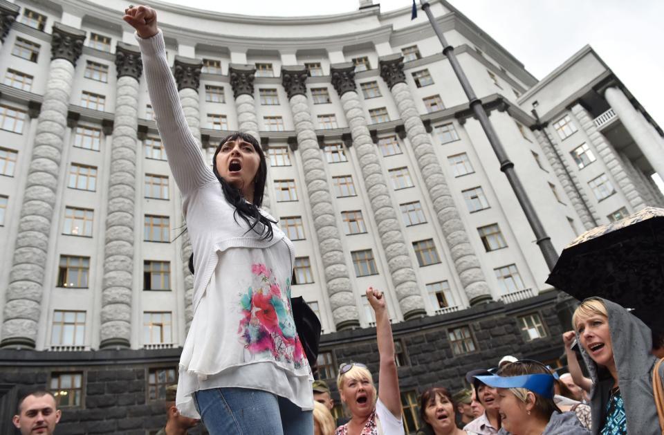 A woman holds up her fist and shouts slogans during a mass rally in front of the Ukrainian Cabinet of the Ministers and the Parliament in Kiev on July 6, 2016.&nbsp;