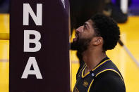 Los Angeles Lakers forward Anthony Davis touches his face to a pad on part of the basket during the second half of an NBA basketball game against the Denver Nuggets Monday, May 3, 2021, in Los Angeles. (AP Photo/Mark J. Terrill)