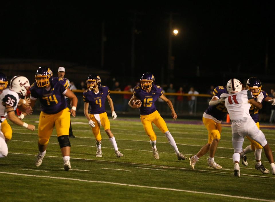 Taylorville's Baron Odam carries the ball during an Apollo Conference football game against Mount Zion on Friday, Sept. 15, 2023.