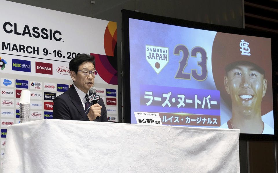 Japan's manager Hideki Kuriyama speaks with St. Louis Cardinals outfielder Lars Nootbaar, seen on a monitor, during a press conference in Tokyo, Japan, Thursday, Jan. 26, 2023. Japan has completed naming it 30-team for the World Baseball Classic that includes Nootbaar and Boston Red Sox outfielder Masataka Yoshida, (Kyodo News via AP)