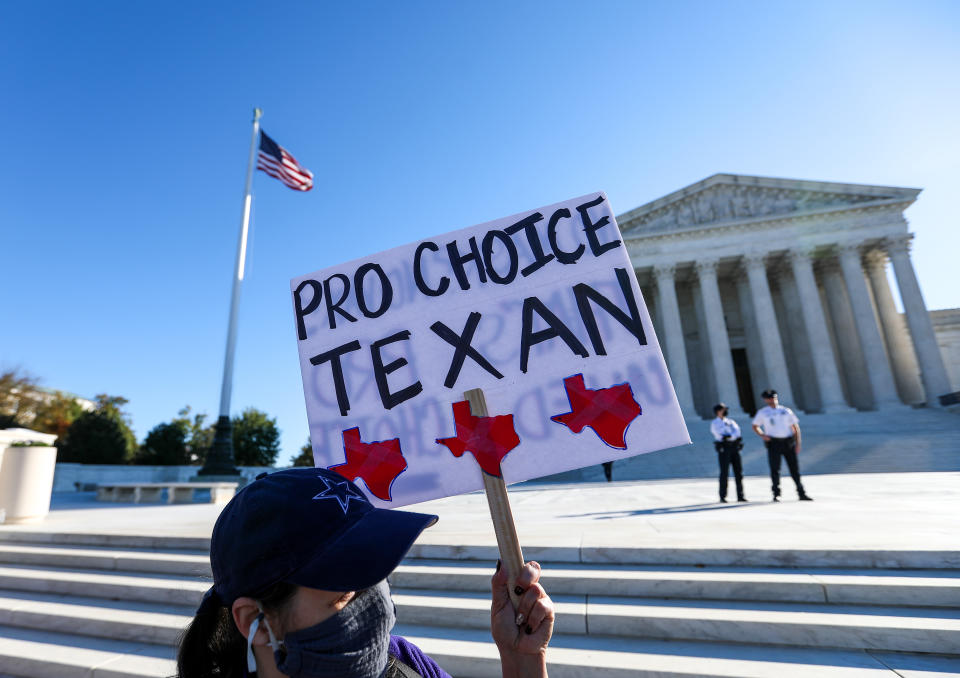 A demonstrator protests outside the Supreme Court as it hears challenges to a controversial new Texas abortion law.