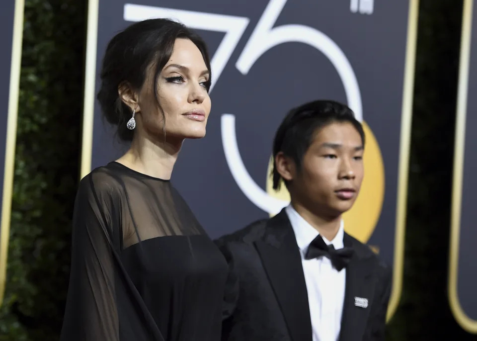 Angelina Jolie and Pax Jolie-Pitt arrive at the Golden Globe Awards at the Beverly Hilton Hotel on Jan. 7. (Photo: Jordan Strauss/Invision/AP)