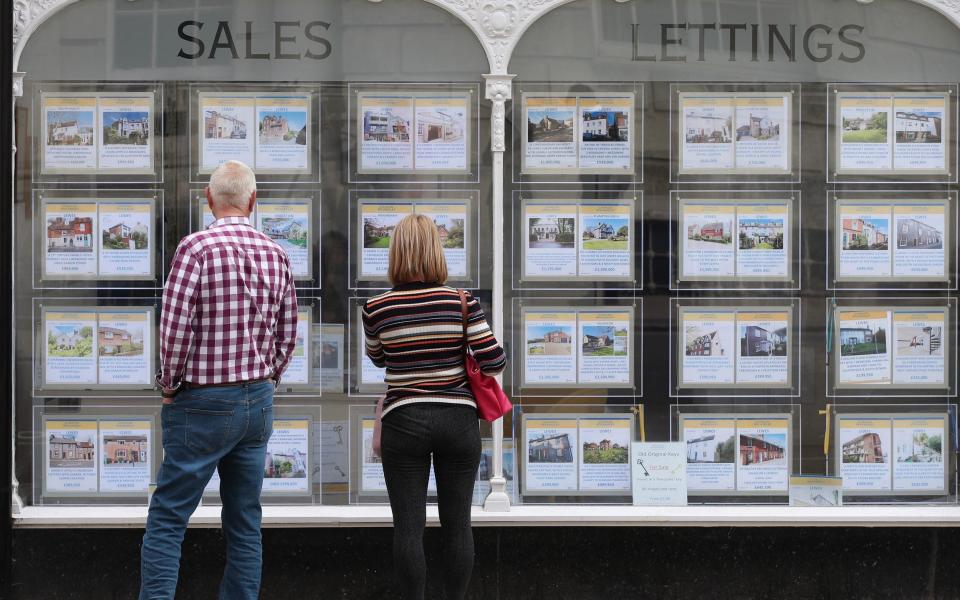  People looking at house price signs displayed in the window of an estate agents in Lewes, East Sussex, as the Office for National Statistics (ONS) has said that the average UK house price has surged by Â£24,000 during the past year of coronavirus lockdowns. Issue date: Wednesday May 19, 2021. - Yui Mok/ PA