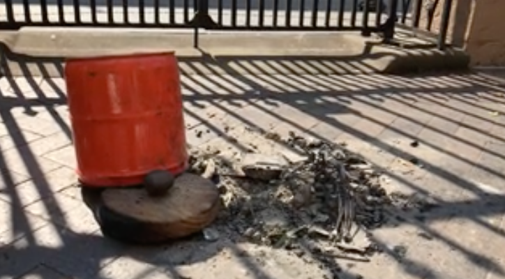 the ashes of Aaron Crowe's home on the ground outside NSW Parliament after the house was destroyed by bushfire. 