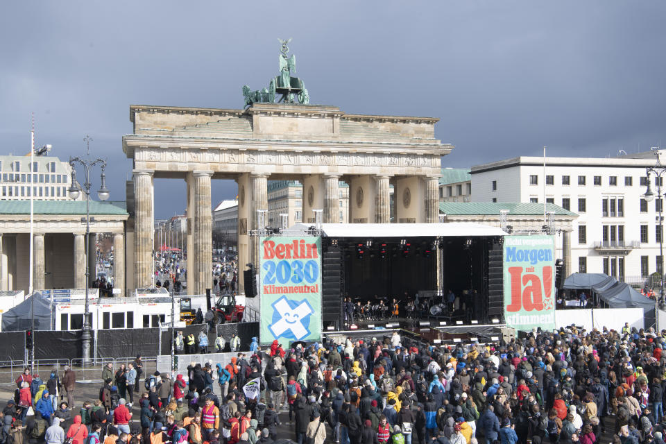 At the start of the "Berlin Climate Aid" concert, only a few people gathered at the Brandenburg Gate in Berlin Saturday, March 25, 2023. The organizers expects 35,000 participants. Voters in Berlin go to the polls this weekend to decide on a proposal that would force the city government to drastically ramp up the German capital’s climate goals. Sunday's referendum, which has attracted considerable financial support from U.S.-based philanthropists, calls for Berlin to become climate neutral by 2030. (Paul Zinken/dpa via AP)