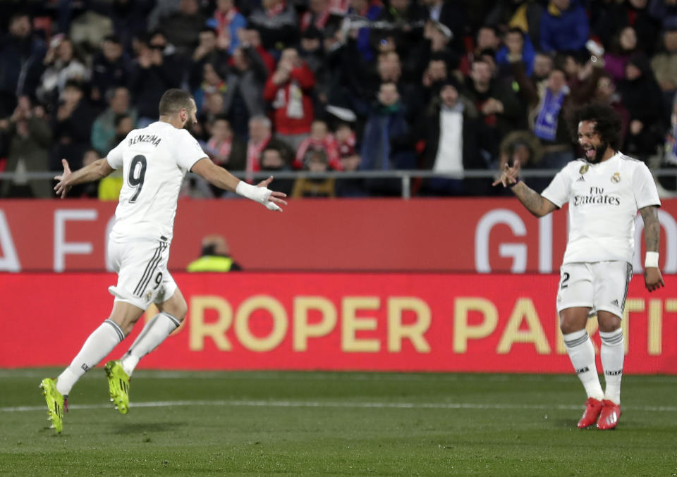 Real Madrid's Benzema, left, celebrates after scoring during a Spanish Copa del Rey soccer match between Girona and Real Madrid at the Montilivi stadium in Girona, Spain, Thursday, Jan. 31, 2019. (AP Photo/Manu Fernandez)