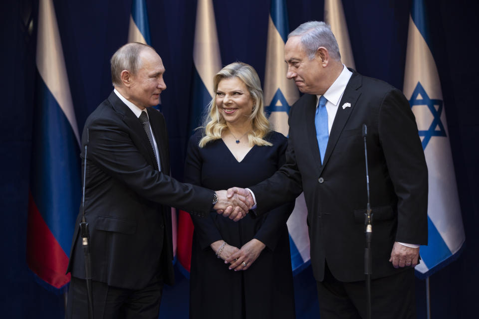 Israeli Prime Minister Benjamin Netanyahu and his wife Sarah meet with Russian President Vladimir Putin, left, at Netanyahu official residence in Jerusalem on Thursday, Jan. 23,2020 . Putin, will be a guest of honor Thursday at a ceremony at the Yad Vashem Holocaust Museum marking the 75th anniversary of the Soviet Red Army's liberation of the Nazi Auschwitz death camp. Presidents , prime ministers and royalty from around the world who arrived in Israel for the two-day World Holocaust Forum in Jerusalem, marking the 75th anniversary of the liberation of the Auschwitz-Birkenau concentration camp.(Heidi Levine/Pool photo via AP)