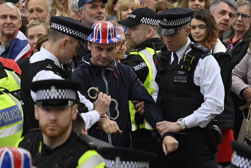 LONDON, ENGLAND - MAY 06: Protesters from climate protest group 'Just Stop Oil' are apprehended by police officers in the crowd during the Coronation of King Charles III and Queen Camilla on May 6, 2023 in London, England. The Coronation of Charles III and his wife, Camilla, as King and Queen of the United Kingdom of Great Britain and Northern Ireland, and the other Commonwealth realms takes place at Westminster Abbey today. Charles acceded to the throne on 8 September 2022, upon the death of his mother, Elizabeth II. (Photo by Justin Tallis - WPA Pool/Getty Images)