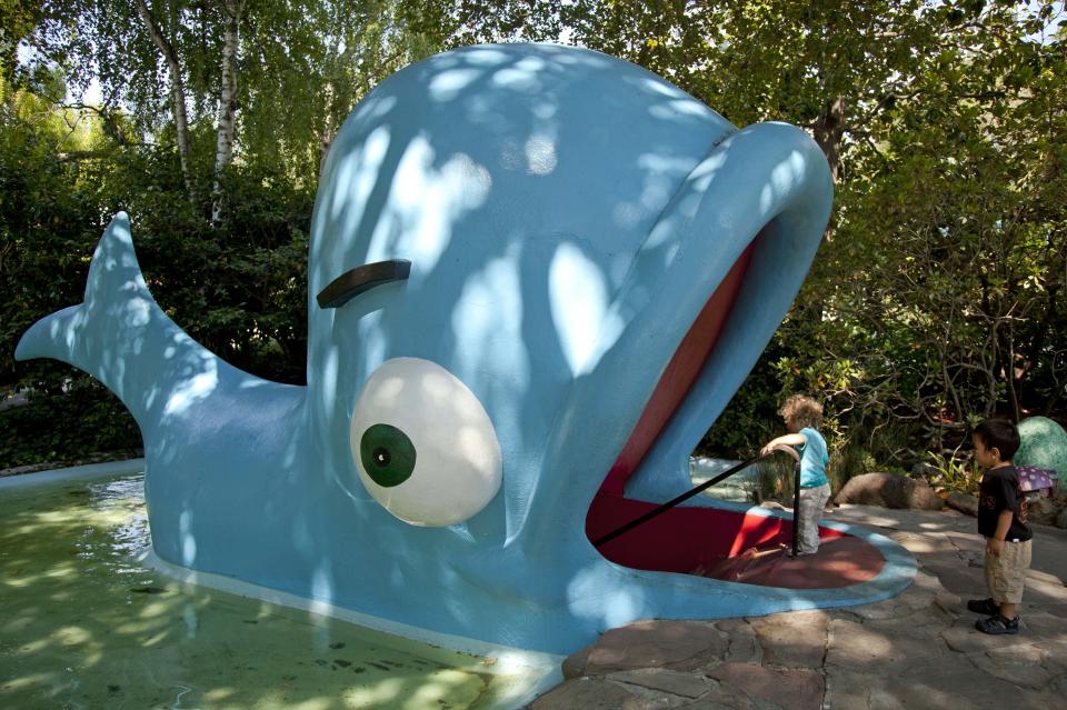 In this photo take Thursday July 12, 2012, children enter the open mouth of "Willie the Whale" at Fairyland in Oakland, Calif. Growing up in the shadow of an icon is never a shoe-in, whether you’re a wannabe princess related to that attention-grabbing vamp Cinderella or a city living next door to fabled San Francisco. (AP Photo/Eric Risberg)
