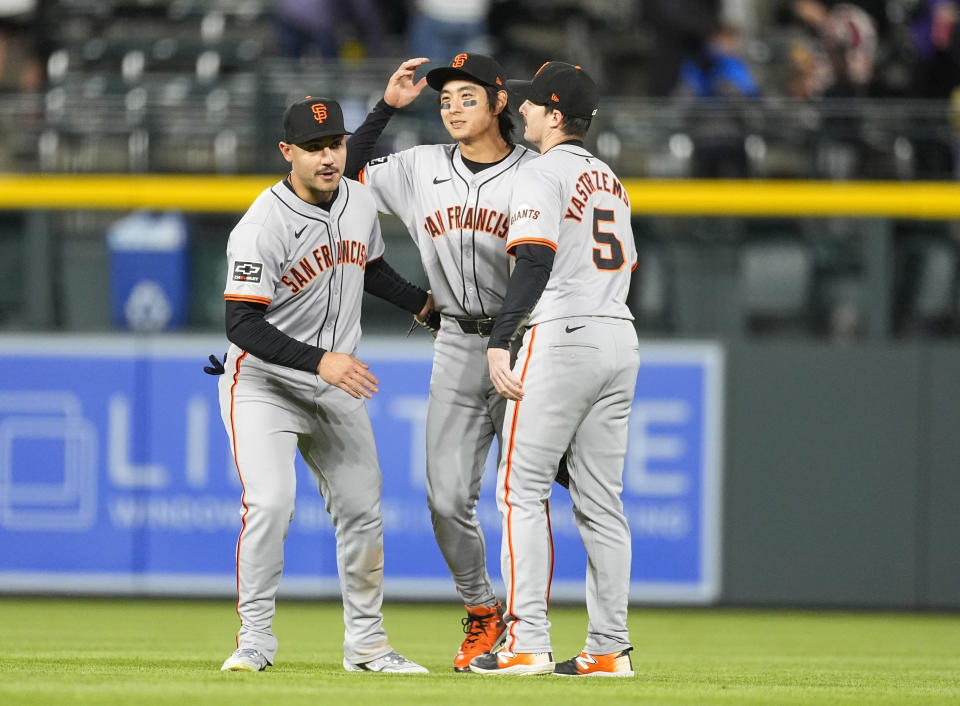 San Francisco Giants left fielder Michael Conforto, center fielder Jung Hoo Lee and right fielder Mike Yastrzemski, from left, celebrate after the team's win in a baseball game against the Colorado Rockies on Wednesday, May 8, 2024, in Denver. (AP Photo/David Zalubowski)