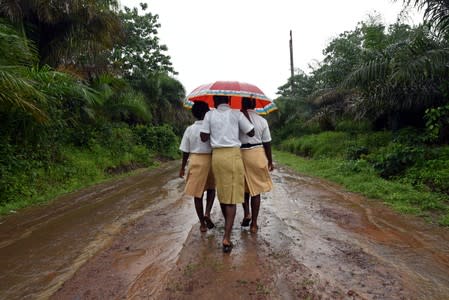 Mariatu Sesay, 15, walks home with her school mates in a countryside village of Sierra Leone