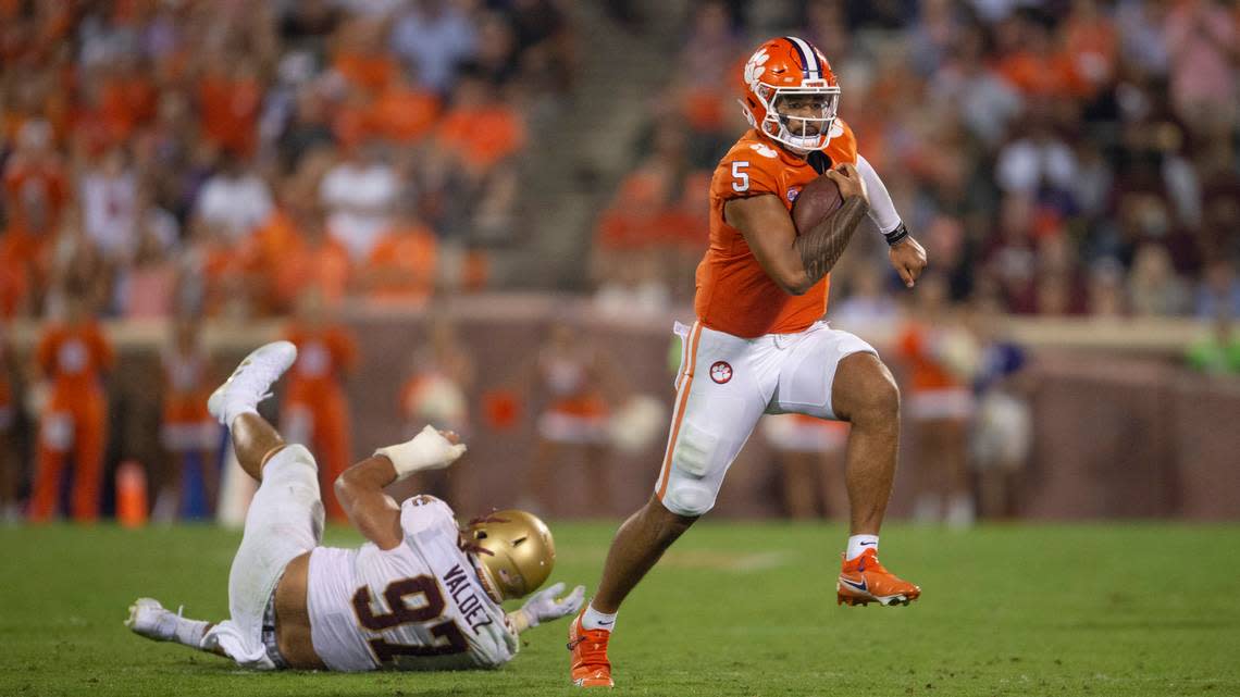 Clemson quarterback D.J. Uiagalelei (5) avoids the tackle by Boston College defensive end Marcus Valdez (97) during the second half of an NCAA college football game against Boston College Saturday, Oct. 2, 2021, in Clemson, S.C. (AP Photo/Hakim Wright Sr.)