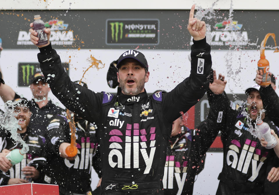 FILE - In this Feb. 10, 2020, file photo, Jimmie Johnson celebrates in Victory Lane after winning the NASCAR Clash auto race at Daytona International Speedway in Daytona Beach, Fla. Seven-time NASCAR champion Jimmie Johnson has twice tested negative for the coronavirus and has been cleared to race Sunday, July 12, 2020 at Kentucky Speedway. Johnson missed the first race of his Cup career when he tested positive last Friday. (AP Photo/John Raoux, File)