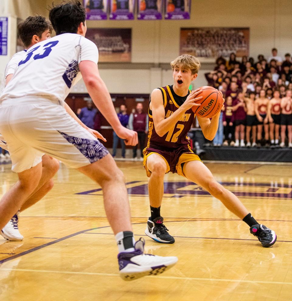 North's Connor O'Guinn (12) drives during the Bloomington North versus Bloomington South boys basketball game at Bloomington High School South on Friday, Jan. 6, 2023.