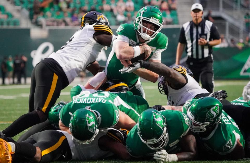 Saskatchewan Roughriders quarterback Shea Patterson (5) dives for a touchdown against Hamilton Tiger-Cats during the second half of CFL football action in Regina, on  June 23, 2024. 