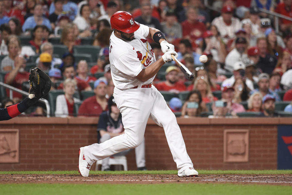 St. Louis Cardinals' Albert Pujols hits a single in the fourth inning of a baseball game against the Atlanta Braves on Friday, Aug. 26, 2022, in St. Louis. (AP Photo/Joe Puetz)