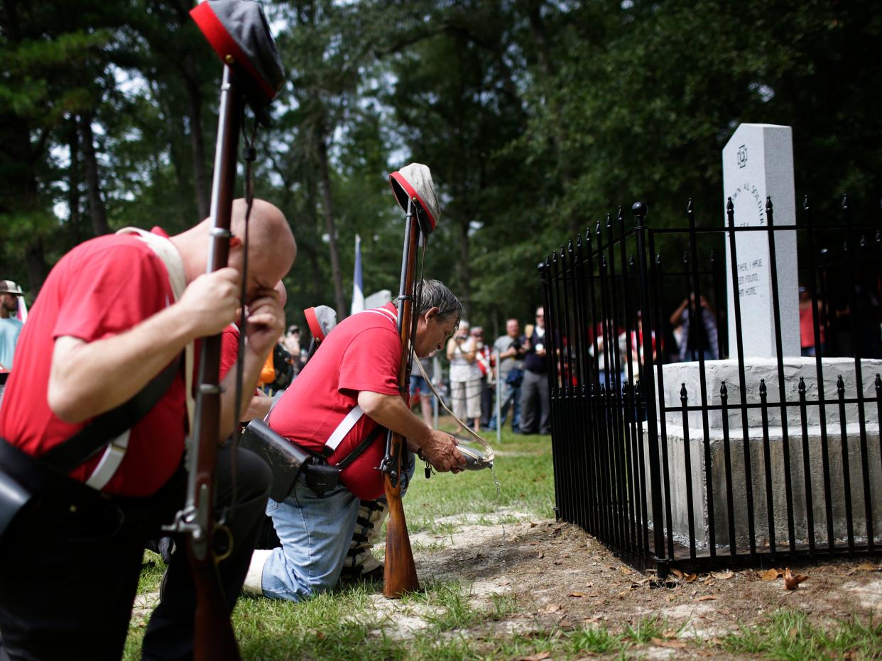 In this Aug. 27, 2017 file photo, members of the Sons of Confederate Veterans kneel in front of a new monument called the "Unknown Alabama Confederate Soldiers" in the Confederate Veterans Memorial Park in Brantley, Ala. As Confederate statues across the nation get removed, covered up or vandalized, some brand new ones are being built as well.