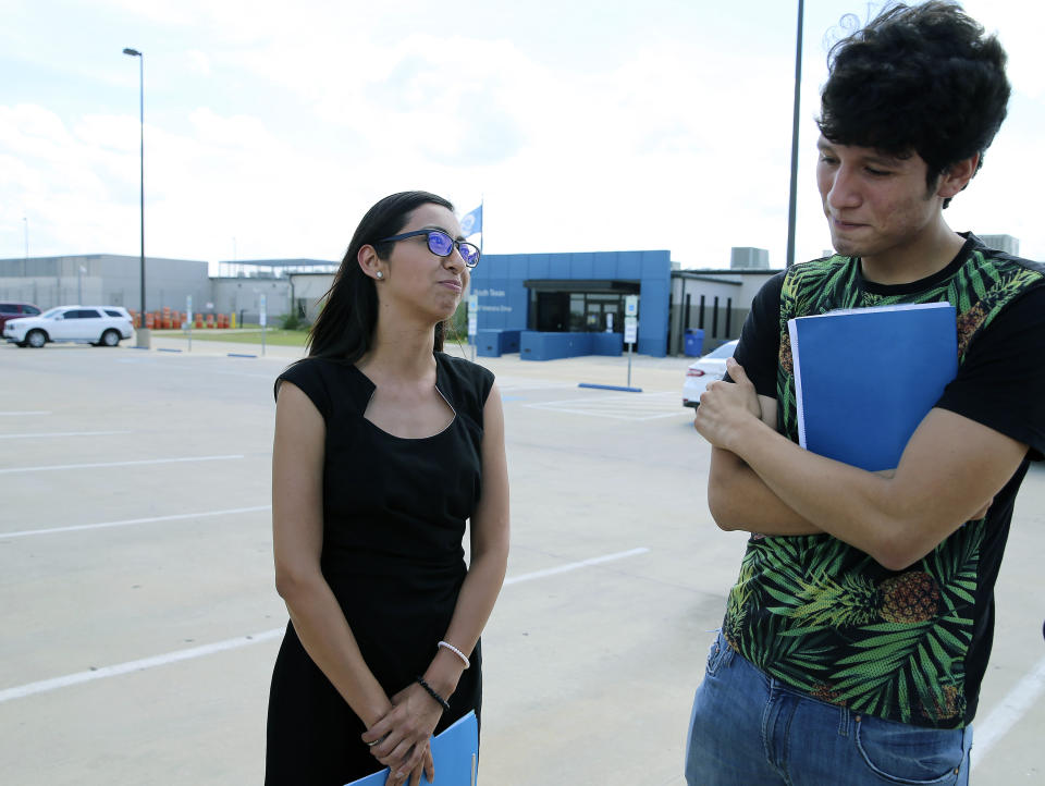 U.S. citizen Francisco Galicia, right, 18, chats with his attorney, Claudia Galan, left, after his release from the South Texas Detention Facility in Pearsall, Texas, Tuesday, July 23, 2019. Galan arrived on Tuesday to present the necessary paperwork for his release and while talking with media on the scene, ICE officials released Galicia from the facility in the same clothing he wore when he was stopped. Galicia who was born in the U.S. was released from immigration custody after wrongfully being detained for more than three weeks. (Kin Man Hui/The San Antonio Express-News via AP)