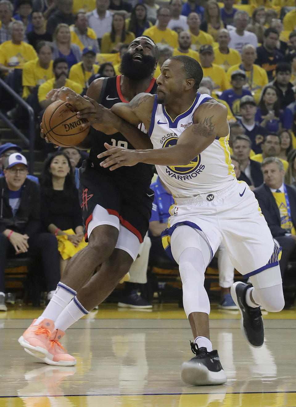 Houston Rockets guard James Harden, left, is fouled by Golden State Warriors guard Andre Iguodala during the first half of Game 1 of a second-round NBA basketball playoff series in Oakland, Calif., Sunday, April 28, 2019. (AP Photo/Jeff Chiu)