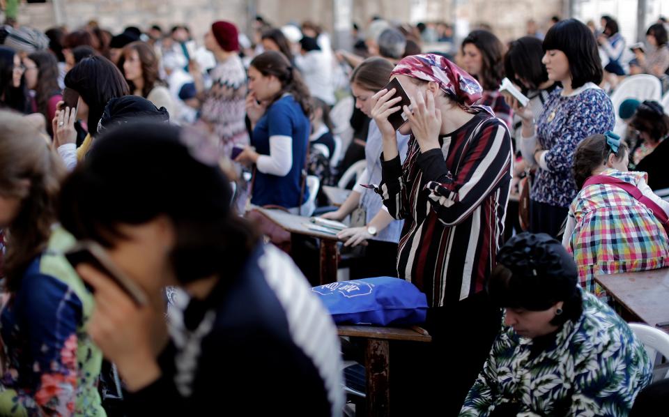 <p>Religious Jewish women pray at the women’s section of the Western Wall in the Old City of Jerusalem on the eve of Yom Kippur also known as the Day of Atonement, the holiest day of the year in Judaism, on Sept. 28, 2017. (Photo: Thomas Coex/AFP/Getty Images) </p>