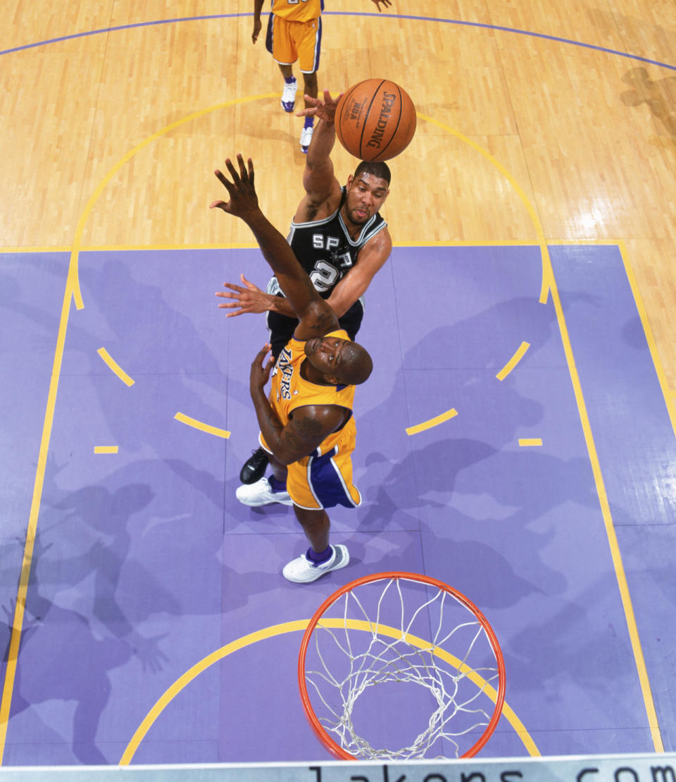 <p>2004: Tim Duncan #21 of the San Antonio Spurs shoots over Shaquille O'Neal #34 of the Los Angeles Lakers in Game Four of the Western Conference Semifinals during the 2004 NBA Playoffs at Staples Center on May 11, 2004 in Los Angeles, California.</p>