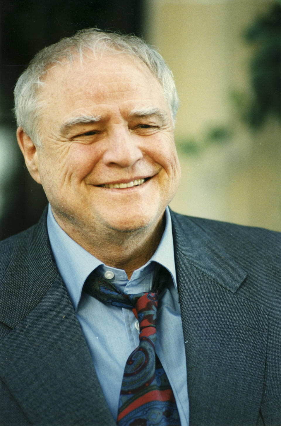 Marlon Brando smiles as he's photographed in Paris circa 1996