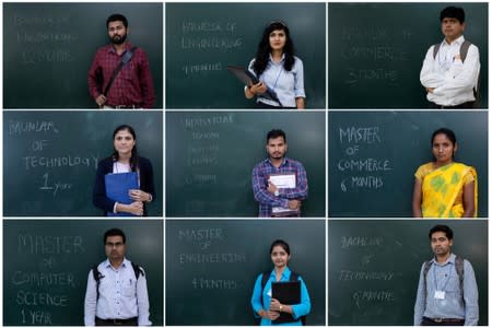 FILE PHOTO: unemployed people posing in front of a chalkboard with their qualifications during a job fair in Chinchwad
