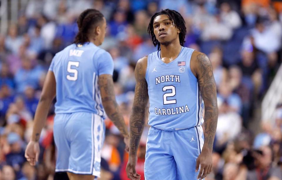 North Carolina’s Caleb Love (2) and Armando Bacot (5) walk back on the court after a timeout during the first half of UNC’s game against Virginia in the quarterfinals of the ACC Men’s Basketball Tournament in Greensboro, N.C., Thursday, March 9, 2023.