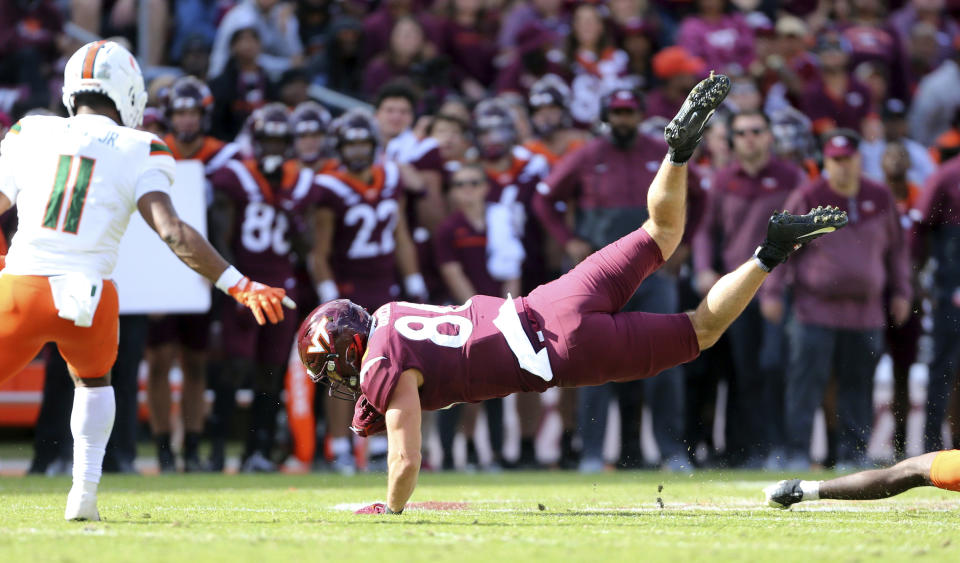 Virginia Tech's Kaleb Smith (80) is upended after catching a pass in the second half of an NCAA football game against Miami, Saturday Oct. 15 2022, in Blacksburg Va. (Matt Gentry/The Roanoke Times via AP)