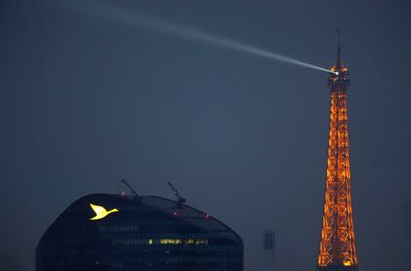 The logo of the French hotel operator AccorHotels group is pictured on their headquarters in Issy-les-Moulineaux as the Eiffel tower is seen in the background, outside Paris, France, February 19, 2017. REUTERS/Christian Hartmann