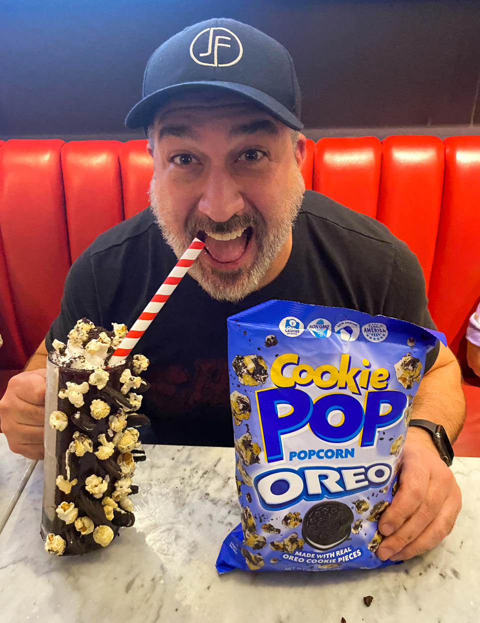 <p>Joey Fatone celebrates National Popcorn Day on Tuesday at Sugar Factory Orlando with a tasty treat featuring Candy Pop and Cookie Pop popcorn made with Oreo cookie pieces.</p>