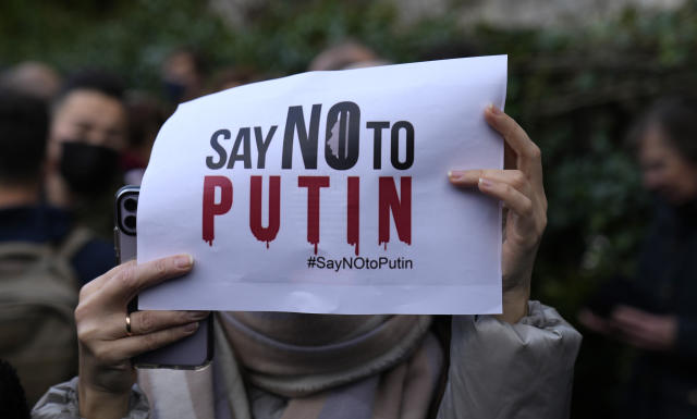 A woman holds up a sign in support of Ukraine during a demonstration in front of the Russian embassy in Paris, France, Tuesday, Feb. 22, 2022. World leaders are getting over the shock of Russian President Vladimir Putin ordering his forces into separatist regions of Ukraine and they are focusing on producing as forceful a reaction as possible. Germany made the first big move Tuesday and took steps to halt the process of certifying the Nord Stream 2 gas pipeline from Russia. (AP Photo/Francois Mori)