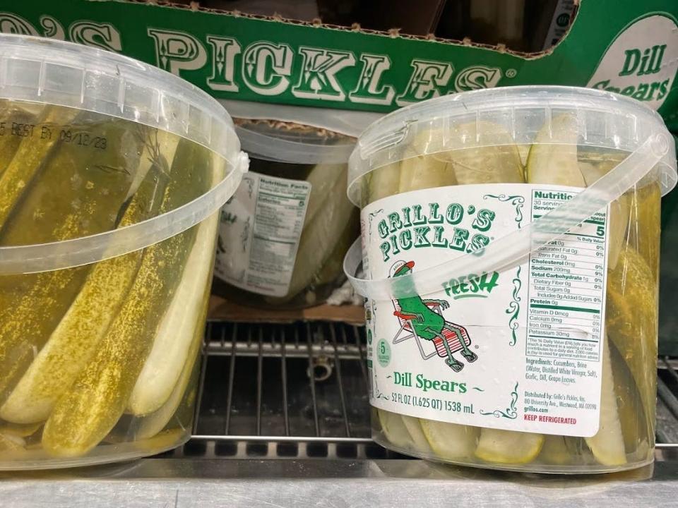 Two large containers of Grillo's pickles.