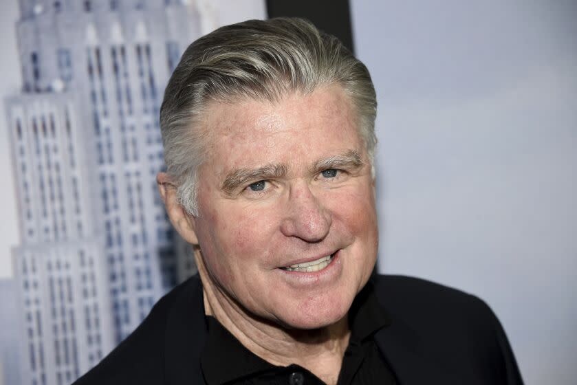 Treat Williams posing in a black shirt against a gray backdrop.