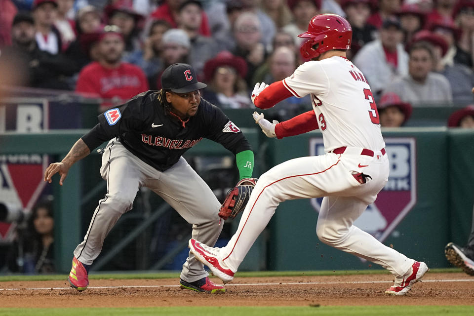 Los Angeles Angels' Taylor Ward, right, is tagged out by Cleveland Guardians third baseman Jose Ramirez as he tries to advance to third on a fielder's choice ball hit by Logan O'Hoppe during the third inning of a baseball game Friday, May 24, 2024, in Anaheim, Calif. (AP Photo/Mark J. Terrill)