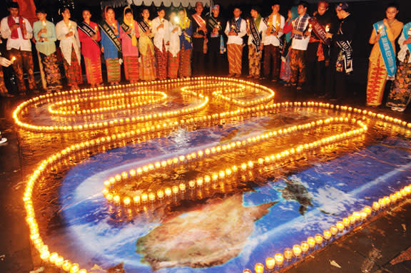 Earth Hour 2010, Citizens of Jakarta in traditional costumes supporting Earth Hour, Jakarta, Java, Indonesia.