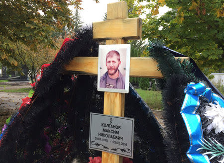 A portrait of Russian contractor Maxim Kolganov, who was killed in combat in Syria, is pictured on a grave in his hometown of Togliatti, Russia, September 29, 2016. REUTERS/Maria Tsvetkova