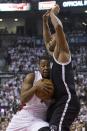 Toronto Raptors' Kyle Lowry, left, drives against Brooklyn Nets' Alan Anderson during the first half of Game 1 of an opening-round NBA basketball playoff series, in Toronto on Saturday, April 19, 2014. (AP Photo/The Canadian Press, Chris Young)