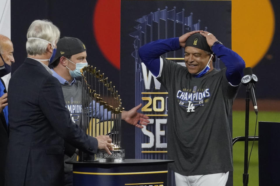 Los Angeles Dodgers manager Dave Roberts celebrates with the trophy after defeating the Tampa Bay Rays 3-1 to win the baseball World Series in Game 6 Tuesday, Oct. 27, 2020, in Arlington, Texas. (AP Photo/Tony Gutierrez)