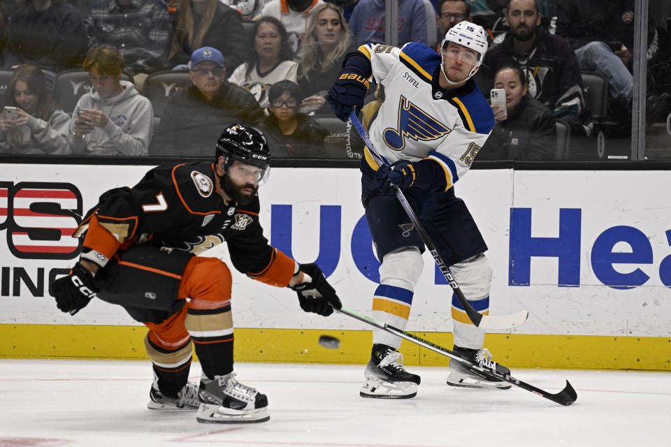 St. Louis Blues left wing Jakub Vrana, right, passes the puck past Anaheim Ducks defenseman Radko Gudas during the first period of an NHL hockey game in Anaheim, Calif., Sunday, Nov. 19, 2023. (AP Photo/Alex Gallardo)