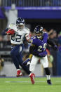Tennessee Titans running back Derrick Henry (22) runs against Baltimore Ravens free safety Earl Thomas (29) during the first half an NFL divisional playoff football game, Saturday, Jan. 11, 2020, in Baltimore. (AP Photo/Gail Burton)