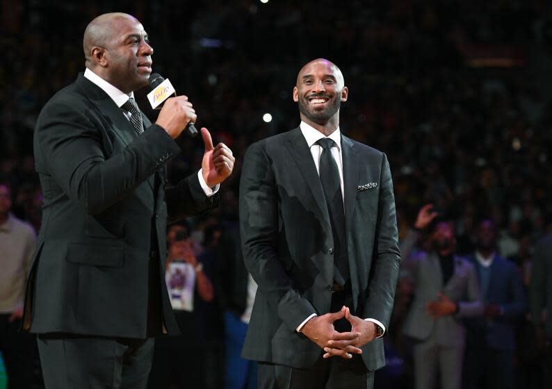 Former Lakers guard Magic Johnson, left, praises Kobe Bryant during a ceremony in 2017.