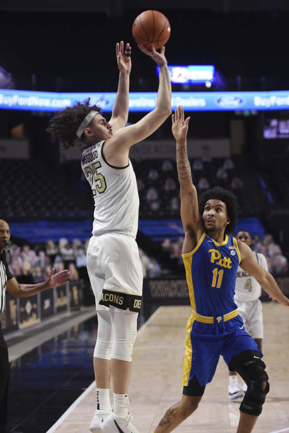 Wake Forest's Ismael Massoud shoots from 3-point range over Pittsburgh's Justin Champagnie during an NCAA college basketball game Saturday, Jan. 23, 2021, in Winston-Salem, N.C. (Walt Unks/The Winston-Salem Journal via AP)