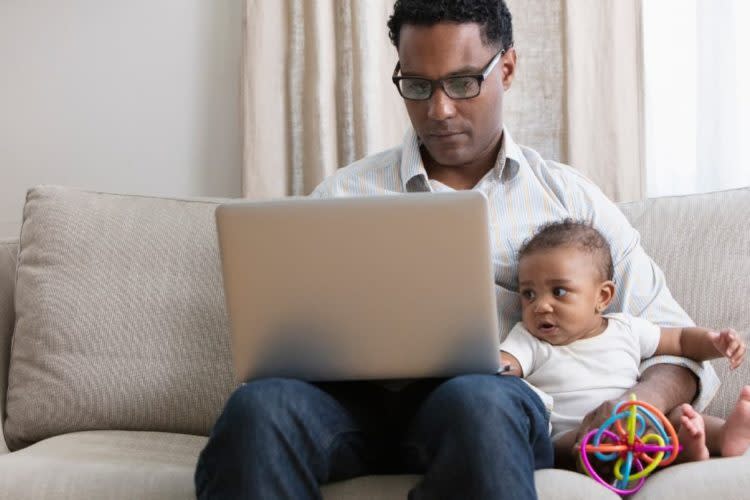 Father working from home and taking care of baby