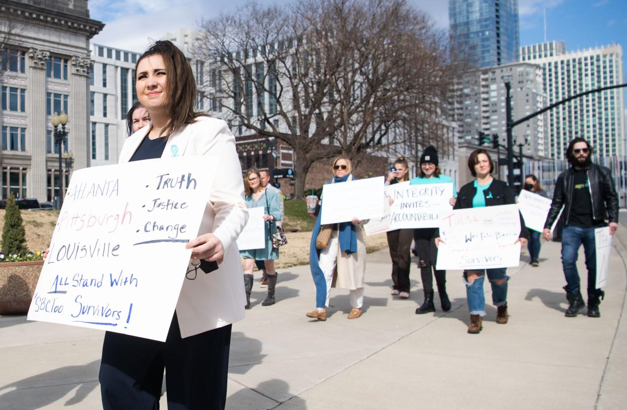 Activists walk in front of the headquarters for the Southern Baptist Convention in Nashville on Feb. 21, calling for better policies to prevent sexual abuse in churches.