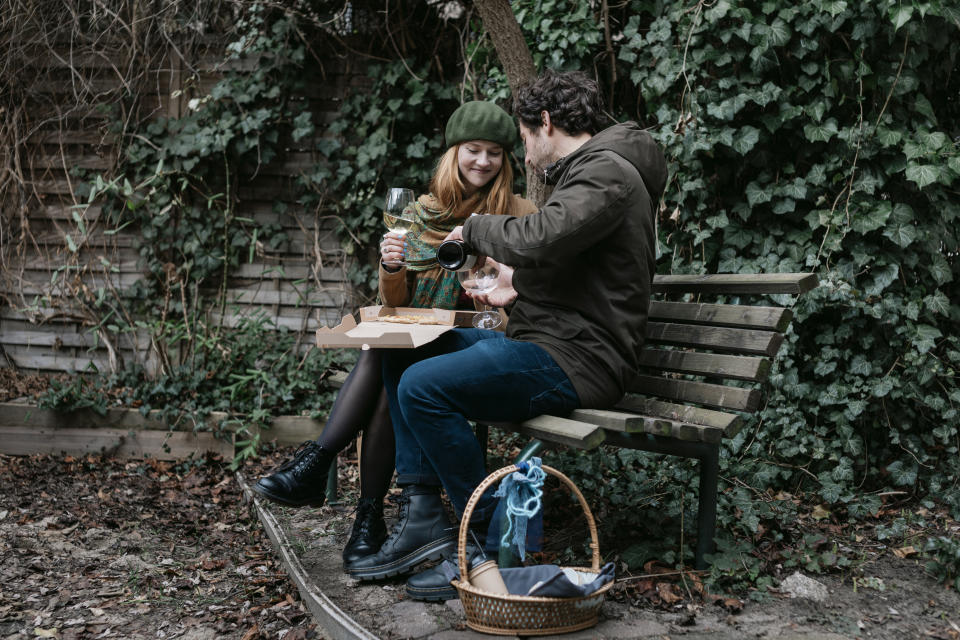 <p>A couple who met on an online dating app sharing a takeout pizza on a park bench together.</p> 