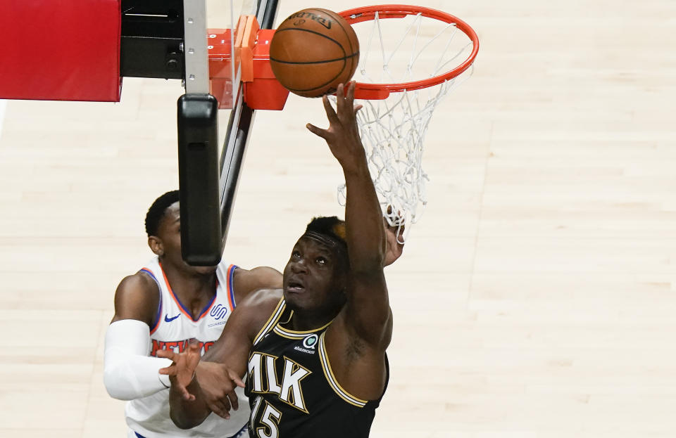 Atlanta Hawks' Clint Capela (15) shoots and scores against the New York Knicks during the first half in Game 4 of an NBA basketball first-round playoff series Sunday, May 30, 2021, in Atlanta. (AP Photo/Brynn Anderson)