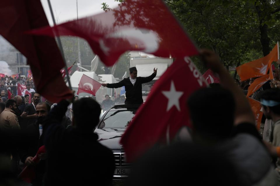 Supporters of the President Recep Tayyip Erdogan celebrate outside AK Party offices in Istanbul, Turkey, Sunday, May 28, 2023. Turkey's incumbent President Recep Tayyip Erdogan has declared victory in his country's runoff election, extending his rule into a third decade. (AP Photo/Khalil Hamra)