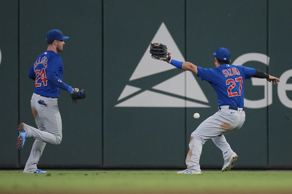 Chicago Cubs right fielder Seiya Suzuki (27) and center fielder Cody Bellinger (24) can't get to a fly ball from Atlanta Braves' Sean Murphy allowing two runs to score in the eighth inning of a baseball game, Tuesday, Sept. 26, 2023, in Atlanta. Suzuki was charged with an error. (AP Photo/John Bazemore)